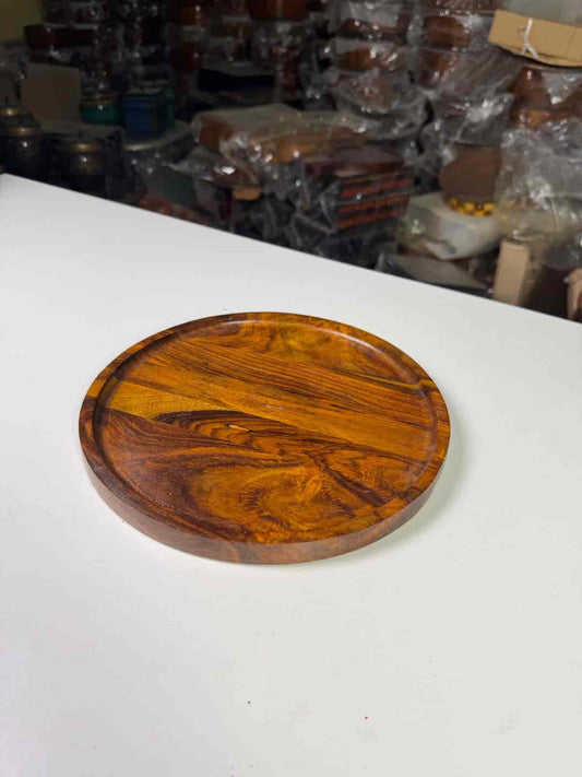 Non-stick perforated pizza pan with raised edges on a kitchen counter

