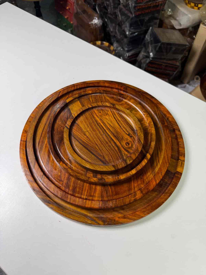 Non-stick perforated pizza pan with raised edges on a kitchen counter

