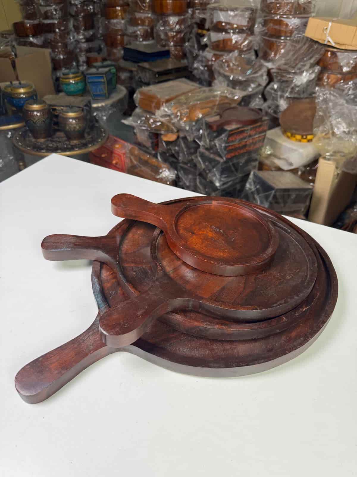 Non-stick pizza pan with handle on a countertop with a freshly baked pizza

